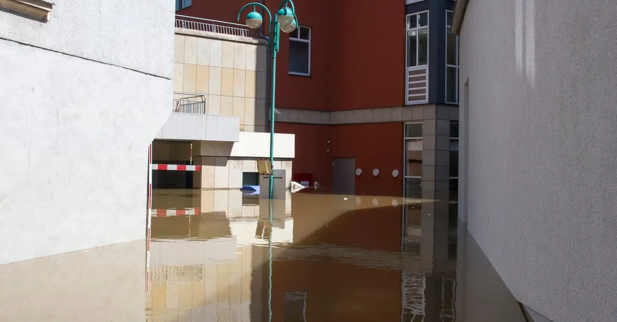Flooded street showing conditions where sump pump or french drain drainage solutions are needed